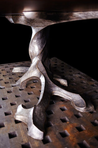 "Twisted Tree" bronze table with Black Walnut bookmatched top.