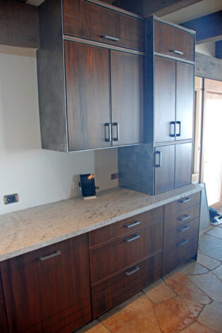 "Snake River" Kitchen on Mahogany framed with Brandner Design Etched Steel.