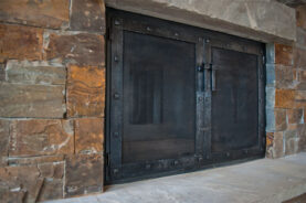 "El Dorado" Fireplace Door in hand hammered black steel.