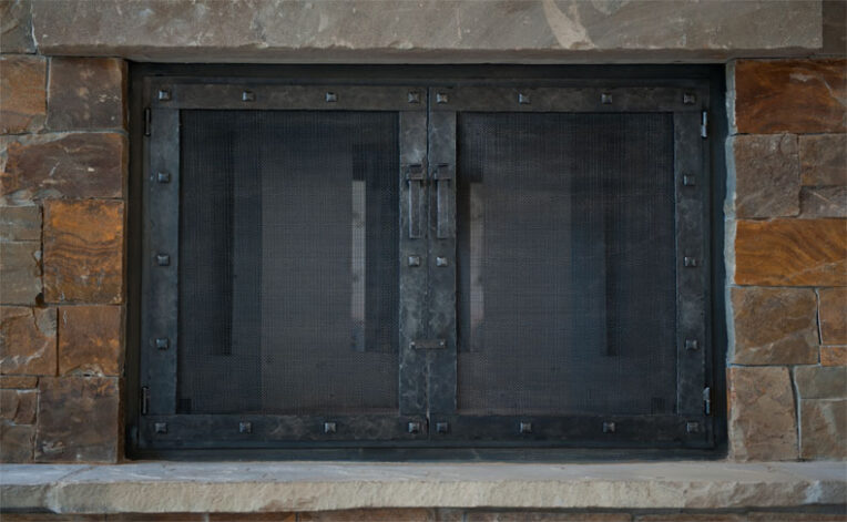 "El Dorado" Fireplace Door in hand hammered black steel.