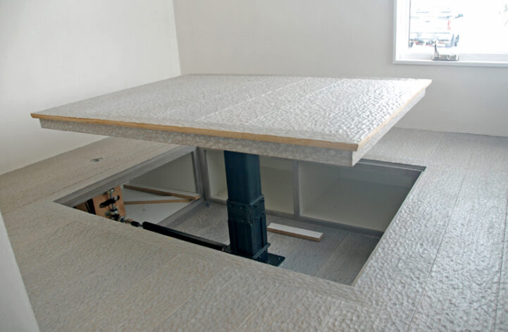 The Crank Coffee Table, rising table hidden on floor.