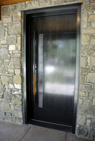 Rockcress Door made with Cherry Wood on the inside and hand patina'd steel on the outside with a hand woven leather pull.