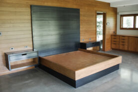 Rockcress Bed with hanging side tables, Cherry wood, and blackened steel.