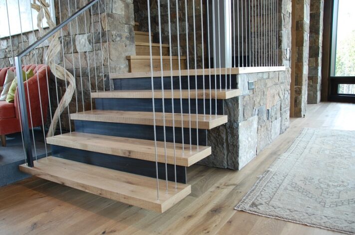 "Waterfall Stair" with White Oak treads hung by stainless steel cables anchored in the ceiling.