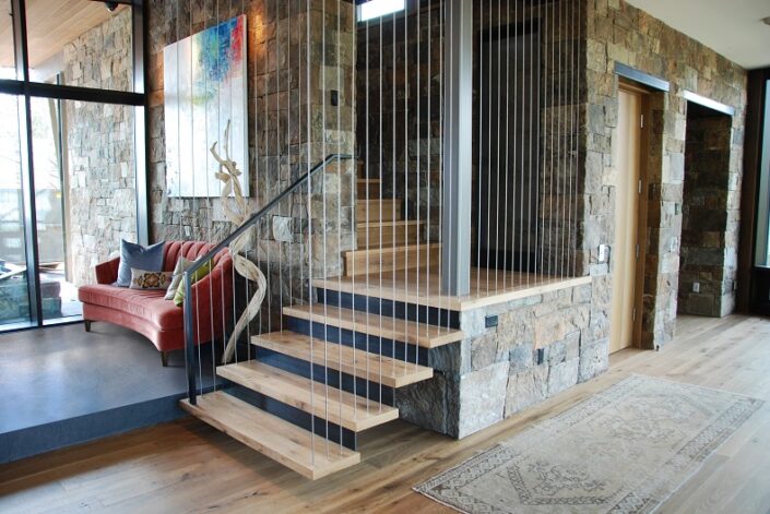 "Waterfall Stair" with White Oak treads hung by stainless steel cables anchored in the ceiling.