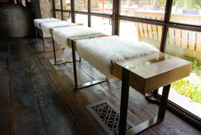 "The Fur Bench" with White Fur dressing on a Black Walnut slab with hand patina'd steel banded legs.