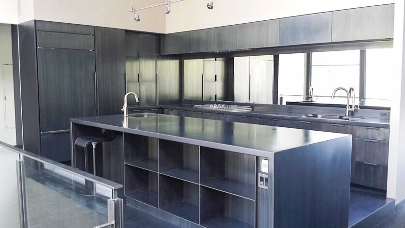 Hilltop Modern Kitchen hand crafted cabinets and black acid washed steel door fronts, counters and center island.