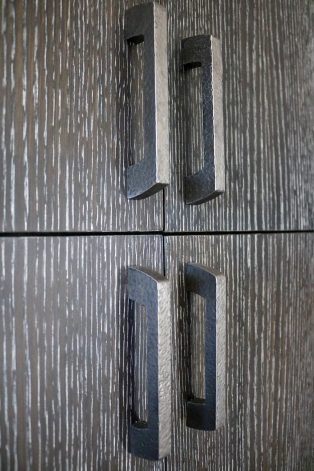 Hand-Hammered Modern Curve Pulls on Midnight Oak Ceruse Cabinets.