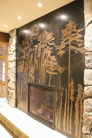 Custom Forest Steel Fireplace Surround made with Acid Patinas for Canyon Hotel in Yellowstone Park.