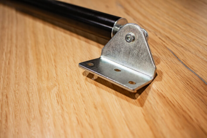 Close-up of the Gas Strut's mounting plate to attach the door. All part of the Floor Door Hinge System.