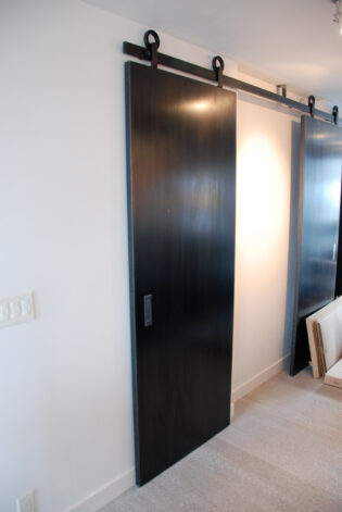 Modern Blackened Steel Sliding Door with a Directional Black Veil patina.