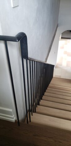 Cheney Lane Staircase white oak treads and a hammered and forged railing system.