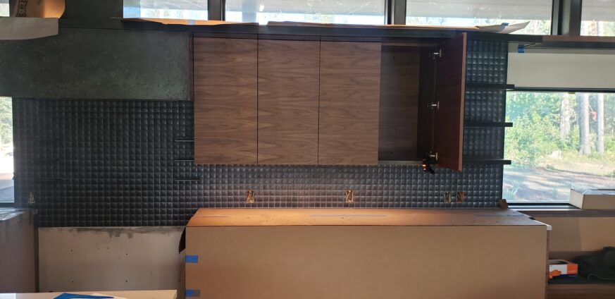 Walnut and stainless-steel Kitchen cabinets at Ross Peak Residency.