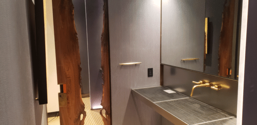 Book Matched Slab Door made in wooden and organic stainless steel inlay.