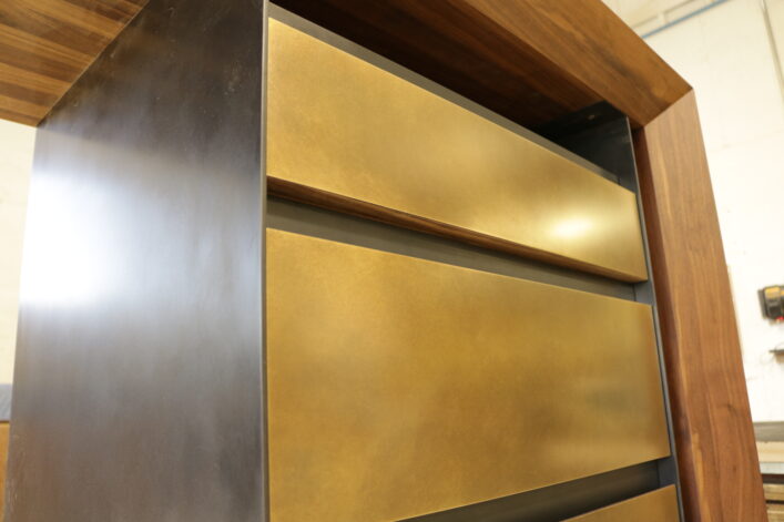 The Recessed Shadow Desk with walnut desktop steel and brass drawers.