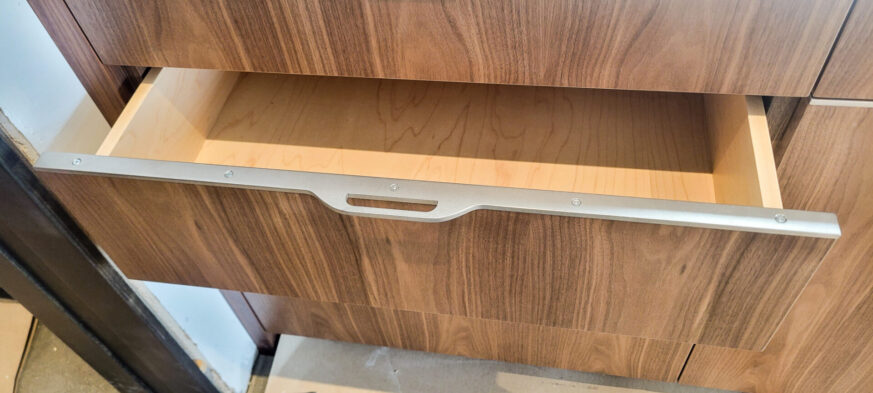 Kitchen Cabinets with walnut veneers and sedan pulls by Brandner Design