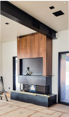 Hot Rolled Steel and Walnut Veneer Fireplace and TV Surround by Brandner Design