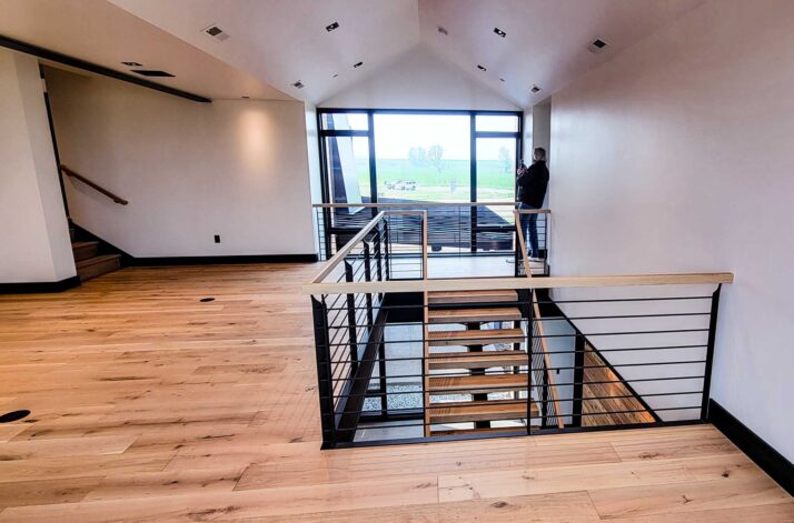 Sales Place Residence custom made stair frame and handrails on blackened steel and white oak treads.