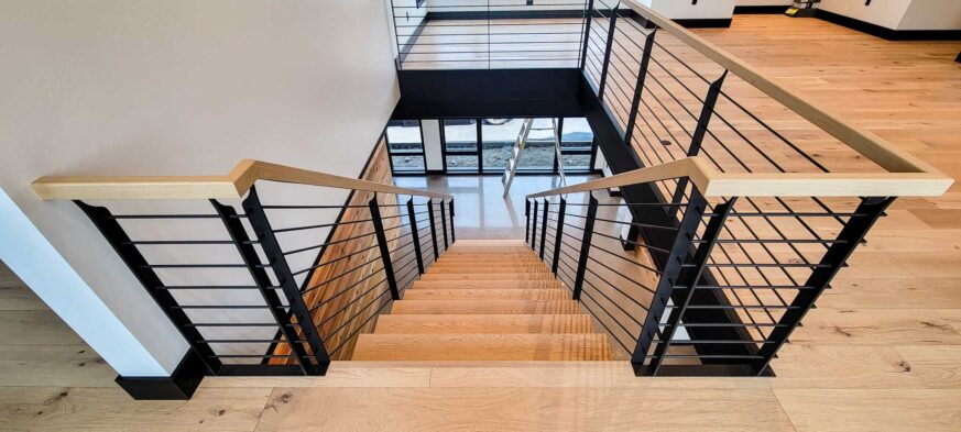 Sales Place Residence custom made stair frame and handrails on blackened steel and white oak treads.