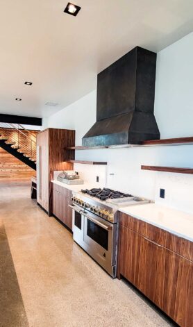 Sales Place Residence Kitchen with a Black Etched Stainless Steel custom made oven hood.