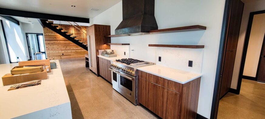 Sales Place Residence Kitchen with a Black Etched Stainless Steel custom made oven hood.