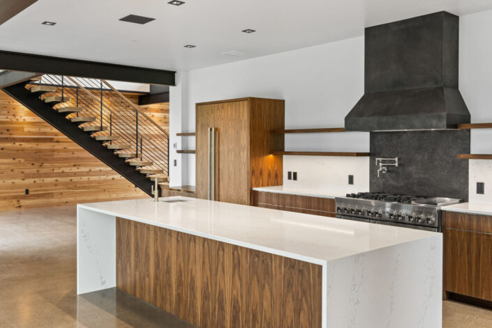 Sales Place Residence kitchen with book-matched walnut veneer cabinets and sedan pulls