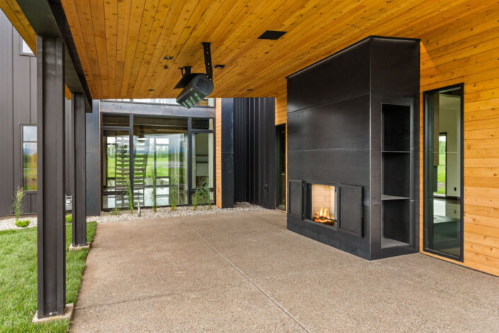 Sales Place Residence Patio with guillotine fireplace and fireplace surround on hot rolled steel panels