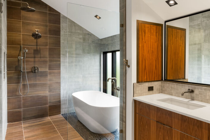 Sales Place Residence Master Bathroom with walnut veneer cabinets and sedan pulls