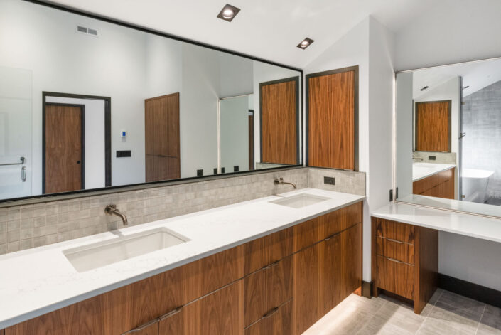 Sales Place Residence Master Bathroom with walnut veneer cabinets and sedan pulls